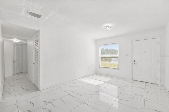 unfurnished room featuring visible vents, marble finish floor, and baseboards