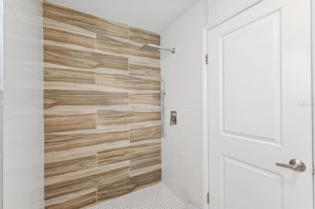bathroom with a tile shower