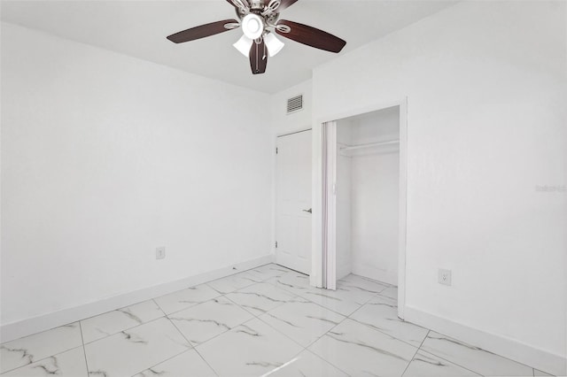 unfurnished bedroom featuring a closet, marble finish floor, visible vents, a ceiling fan, and baseboards