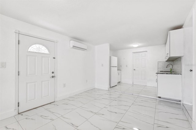interior space with baseboards, a wall unit AC, and marble finish floor