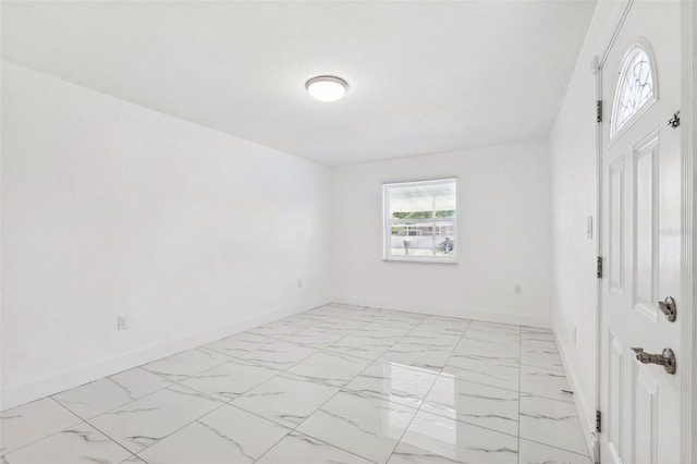 empty room with marble finish floor and baseboards