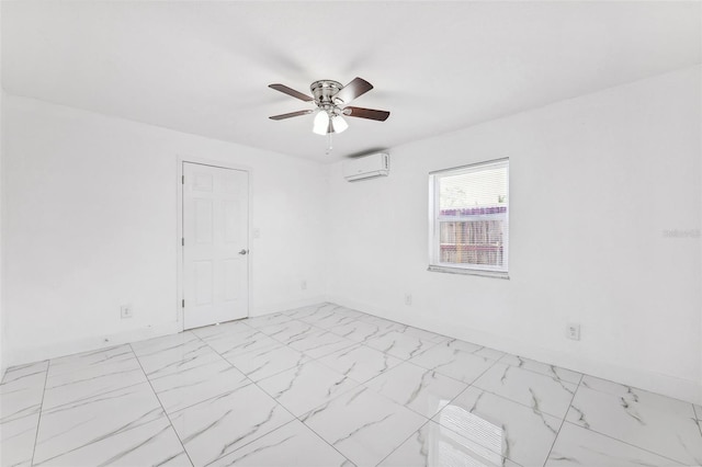 empty room with baseboards, a ceiling fan, marble finish floor, and a wall mounted AC