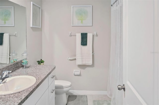 full bath featuring toilet, baseboards, tile patterned flooring, and vanity