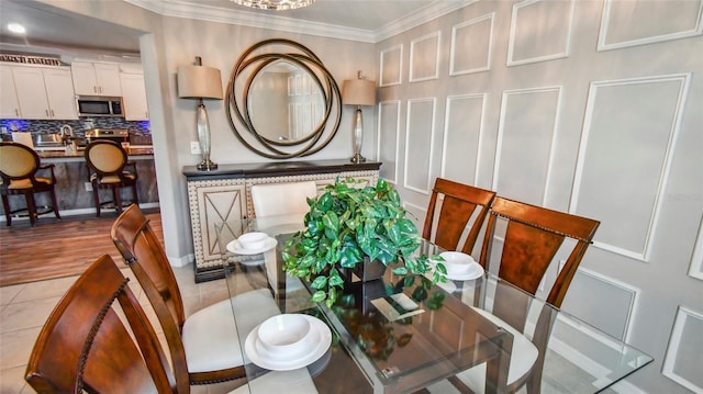 dining room featuring tile patterned floors and ornamental molding