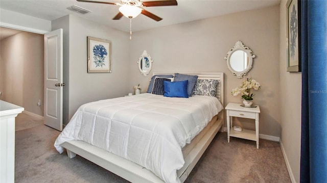 carpeted bedroom featuring visible vents, baseboards, and ceiling fan
