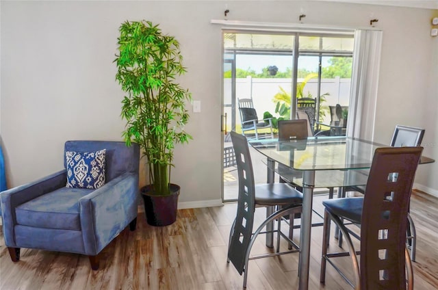 dining room with baseboards and wood finished floors
