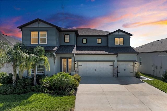13071 Willow Grove Dr, Riverview, FL 33579 - view of front of property featuring a garage, stone siding, stucco siding, a shingled roof, and concrete driveway