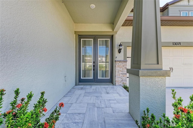13071 Willow Grove Dr, Riverview, FL 33579 - property entrance featuring french doors, stucco siding, and stone siding