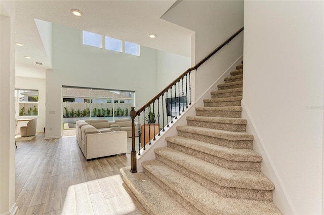 13071 Willow Grove Dr, Riverview, FL 33579 - staircase with recessed lighting, a high ceiling, visible vents, and wood finished floors