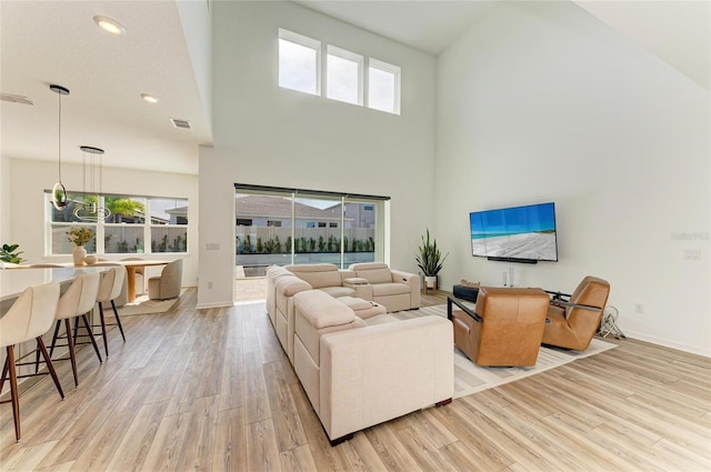 13071 Willow Grove Dr, Riverview, FL 33579 - living area with a towering ceiling, visible vents, baseboards, recessed lighting, and light wood-style flooring