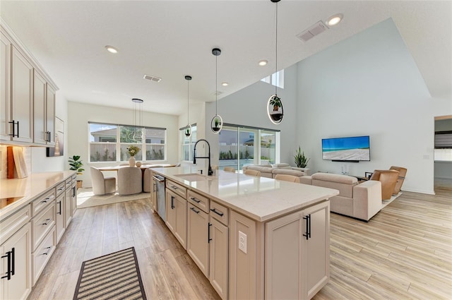 13071 Willow Grove Dr, Riverview, FL 33579 - kitchen featuring visible vents, pendant lighting, stainless steel dishwasher, a sink, and light wood-style flooring