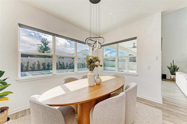 13071 Willow Grove Dr, Riverview, FL 33579 - dining space with baseboards, a chandelier, and light wood finished floors