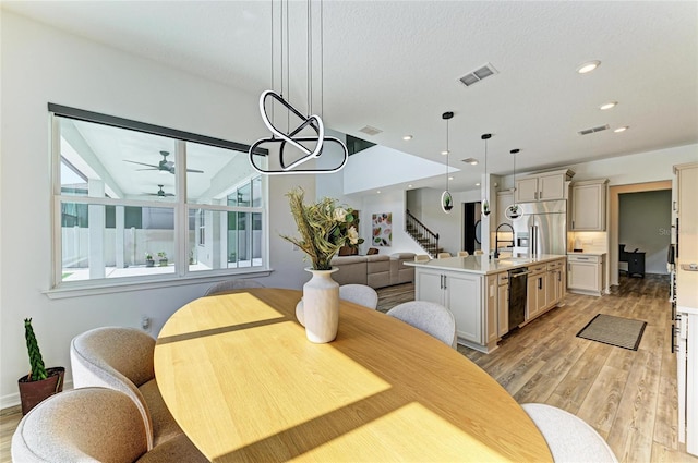 13071 Willow Grove Dr, Riverview, FL 33579 - dining room featuring ceiling fan, light wood finished floors, and visible vents
