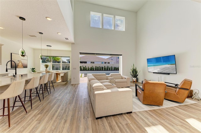 13071 Willow Grove Dr, Riverview, FL 33579 - living area featuring recessed lighting, a high ceiling, a healthy amount of sunlight, and light wood-style flooring
