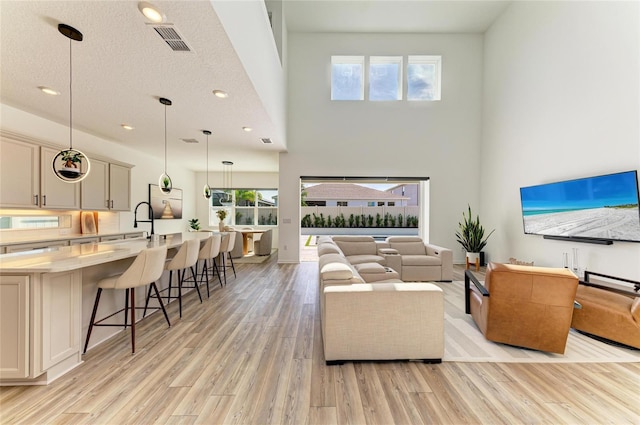 13071 Willow Grove Dr, Riverview, FL 33579 - living area featuring recessed lighting, visible vents, a healthy amount of sunlight, and light wood-style floors