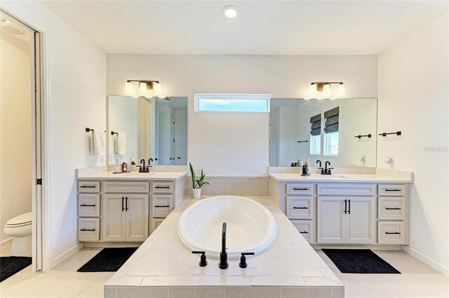 13071 Willow Grove Dr, Riverview, FL 33579 - full bathroom featuring a sink, a bath, toilet, and two vanities