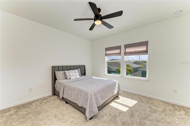 13071 Willow Grove Dr, Riverview, FL 33579 - bedroom with baseboards, ceiling fan, and light carpet