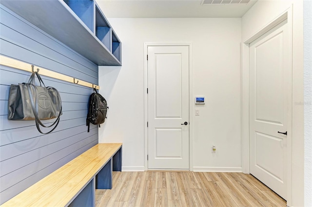 13071 Willow Grove Dr, Riverview, FL 33579 - mudroom featuring light wood-style floors, baseboards, visible vents, and wooden walls