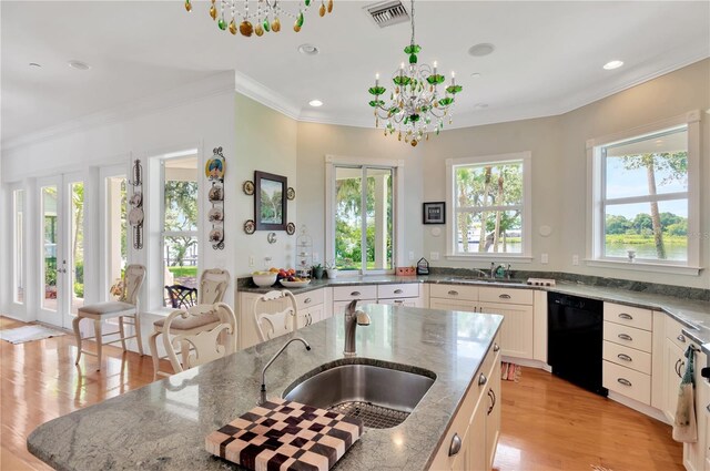 16470 Oakview Cir, Alva, FL 33920 - kitchen featuring light stone countertops, black dishwasher, a sink, visible vents, and a notable chandelier