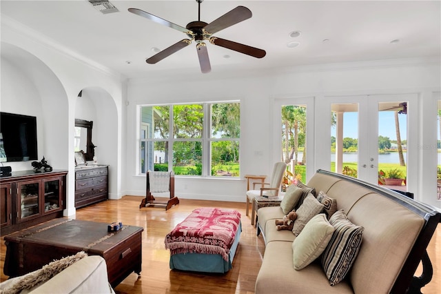 16470 Oakview Cir, Alva, FL 33920 - living area featuring light wood-style flooring, visible vents, a water view, ornamental molding, and a ceiling fan