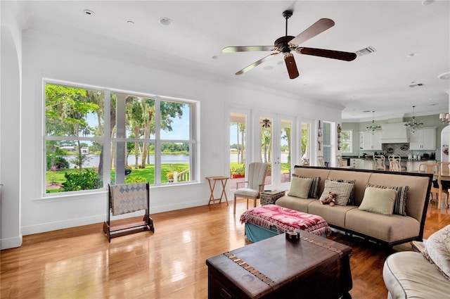 16470 Oakview Cir, Alva, FL 33920 - living room featuring ceiling fan, visible vents, light wood-style flooring, baseboards, and ornamental molding