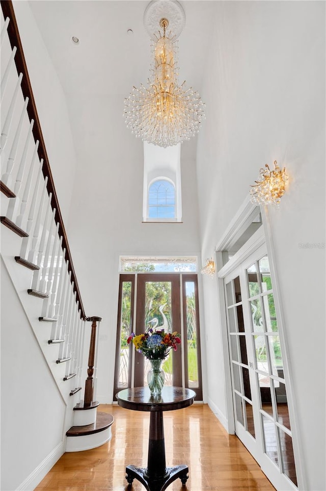 16470 Oakview Cir, Alva, FL 33920 - entrance foyer with an inviting chandelier, wood finished floors, stairs, and a high ceiling