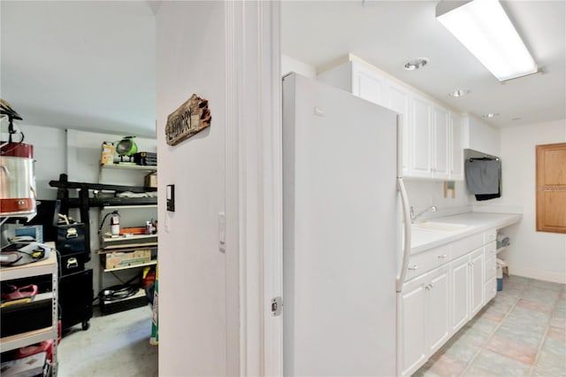 16470 Oakview Cir, Alva, FL 33920 - interior space with white cabinets, a sink, light countertops, and freestanding refrigerator