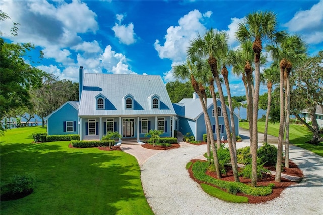 16470 Oakview Cir, Alva, FL 33920 - cape cod house featuring a porch, a front yard, metal roof, and curved driveway