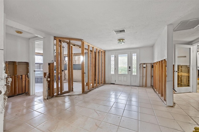 7247 Oelsner St, New Port Richey, FL 34652 - foyer featuring light tile patterned floors, visible vents, and a textured ceiling