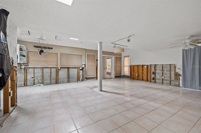 7247 Oelsner St, New Port Richey, FL 34652 - below grade area featuring ceiling fan, a textured ceiling, and tile patterned floors
