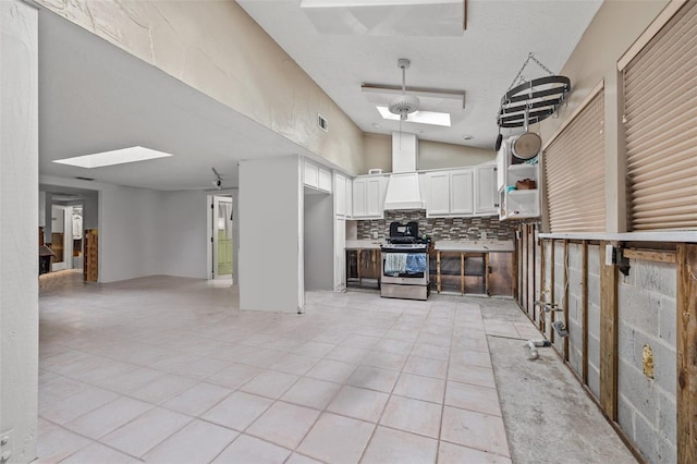 7247 Oelsner St, New Port Richey, FL 34652 - kitchen with open shelves, gas stove, white cabinetry, open floor plan, and decorative backsplash