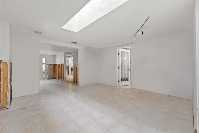7247 Oelsner St, New Port Richey, FL 34652 - unfurnished living room featuring rail lighting, a skylight, and visible vents