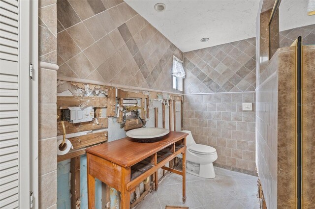 7247 Oelsner St, New Port Richey, FL 34652 - full bath with toilet, tile walls, tile patterned flooring, and vanity