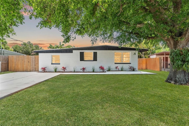 single story home with fence and a front lawn