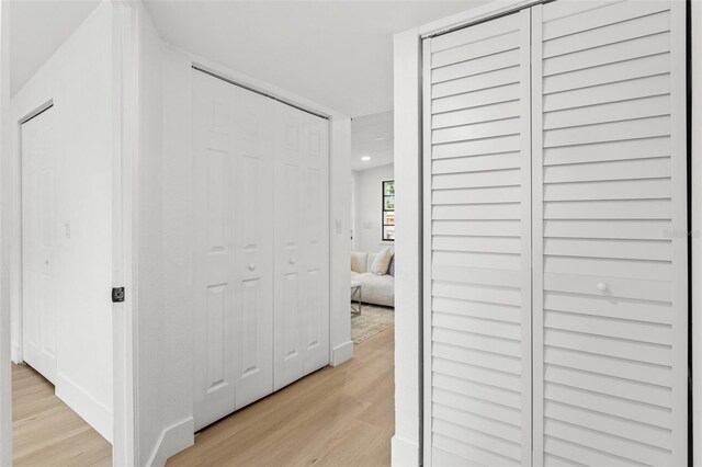 hallway with recessed lighting and light wood-style flooring