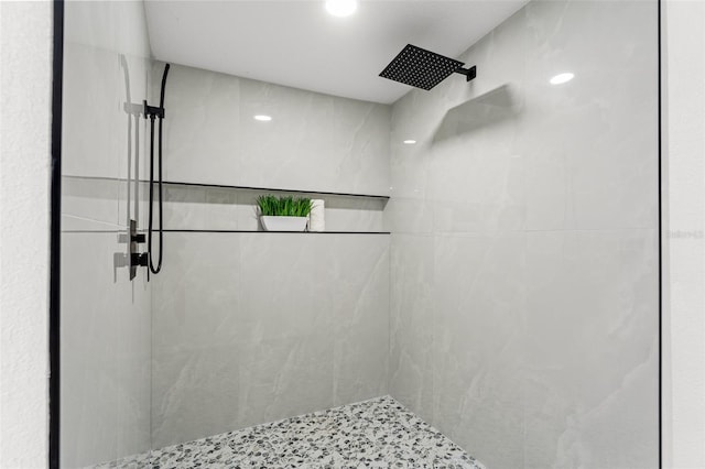 bathroom with recessed lighting and tiled shower