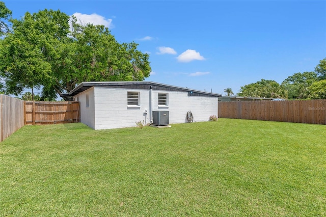 view of outdoor structure with a fenced backyard and central AC unit