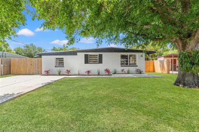 ranch-style home with fence and a front yard