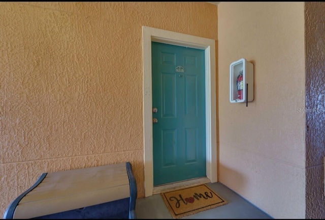 property entrance with stucco siding