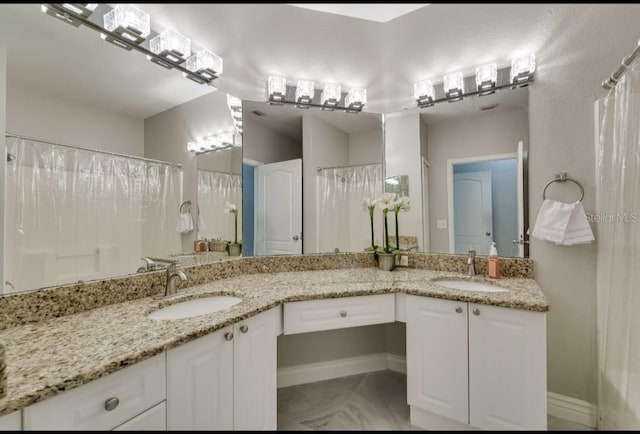 bathroom with double vanity and a sink
