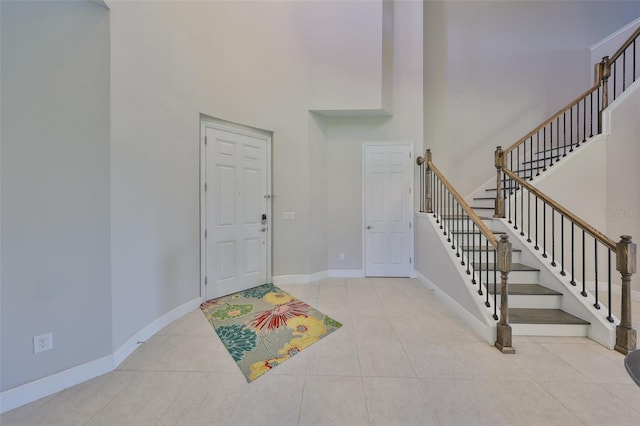 11909 Climbing Fern Ave, Riverview, FL 33579 - tiled entrance foyer featuring a high ceiling, stairway, and baseboards