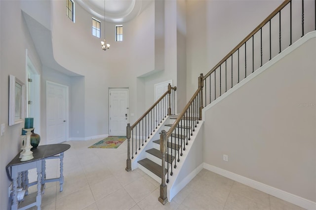 11909 Climbing Fern Ave, Riverview, FL 33579 - foyer with a chandelier, baseboards, a towering ceiling, tile patterned flooring, and stairs