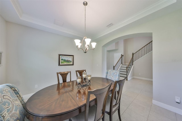 11909 Climbing Fern Ave, Riverview, FL 33579 - dining space featuring crown molding, arched walkways, an inviting chandelier, and baseboards