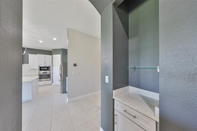 11909 Climbing Fern Ave, Riverview, FL 33579 - bathroom featuring tasteful backsplash, a textured wall, baseboards, recessed lighting, and tile patterned flooring