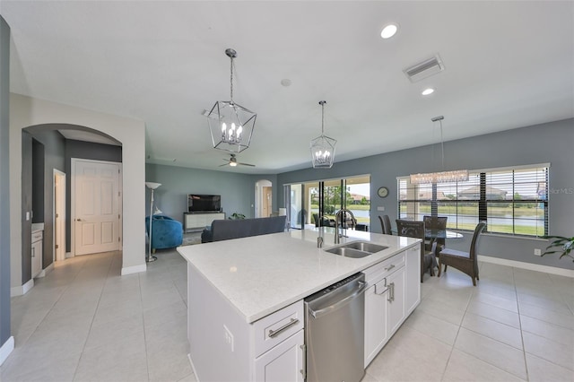 11909 Climbing Fern Ave, Riverview, FL 33579 - kitchen with light tile patterned floors, dishwasher, a sink, and arched walkways