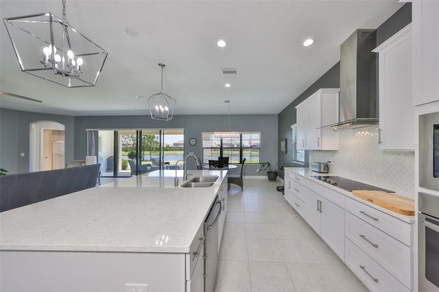 11909 Climbing Fern Ave, Riverview, FL 33579 - kitchen with appliances with stainless steel finishes, a chandelier, wall chimney exhaust hood, and a sink