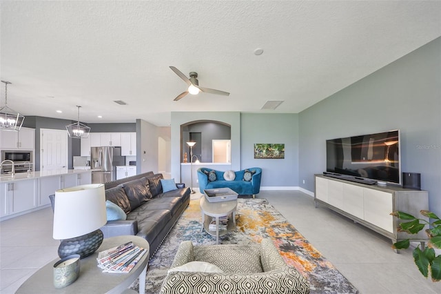 11909 Climbing Fern Ave, Riverview, FL 33579 - living area with baseboards, visible vents, ceiling fan, and light tile patterned flooring
