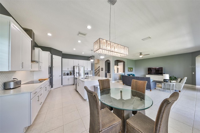 11909 Climbing Fern Ave, Riverview, FL 33579 - dining space featuring light tile patterned floors, arched walkways, visible vents, and ceiling fan