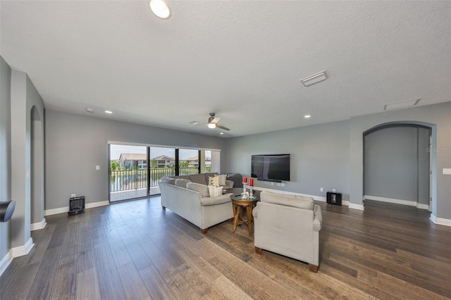 11909 Climbing Fern Ave, Riverview, FL 33579 - living room featuring arched walkways, ceiling fan, and dark wood-type flooring