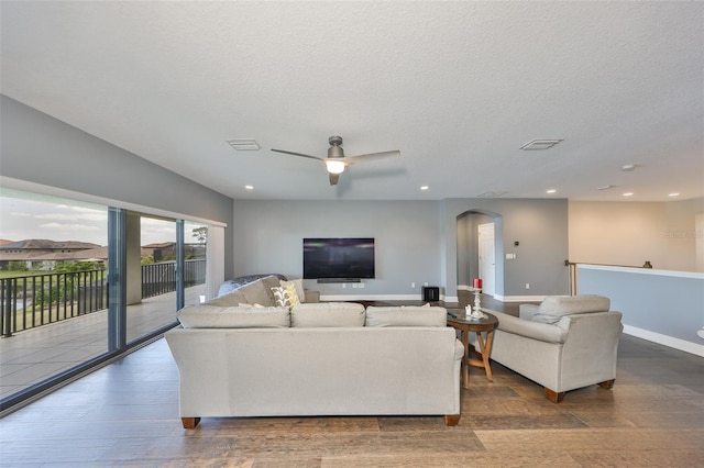 11909 Climbing Fern Ave, Riverview, FL 33579 - living room featuring arched walkways, visible vents, ceiling fan, and wood finished floors